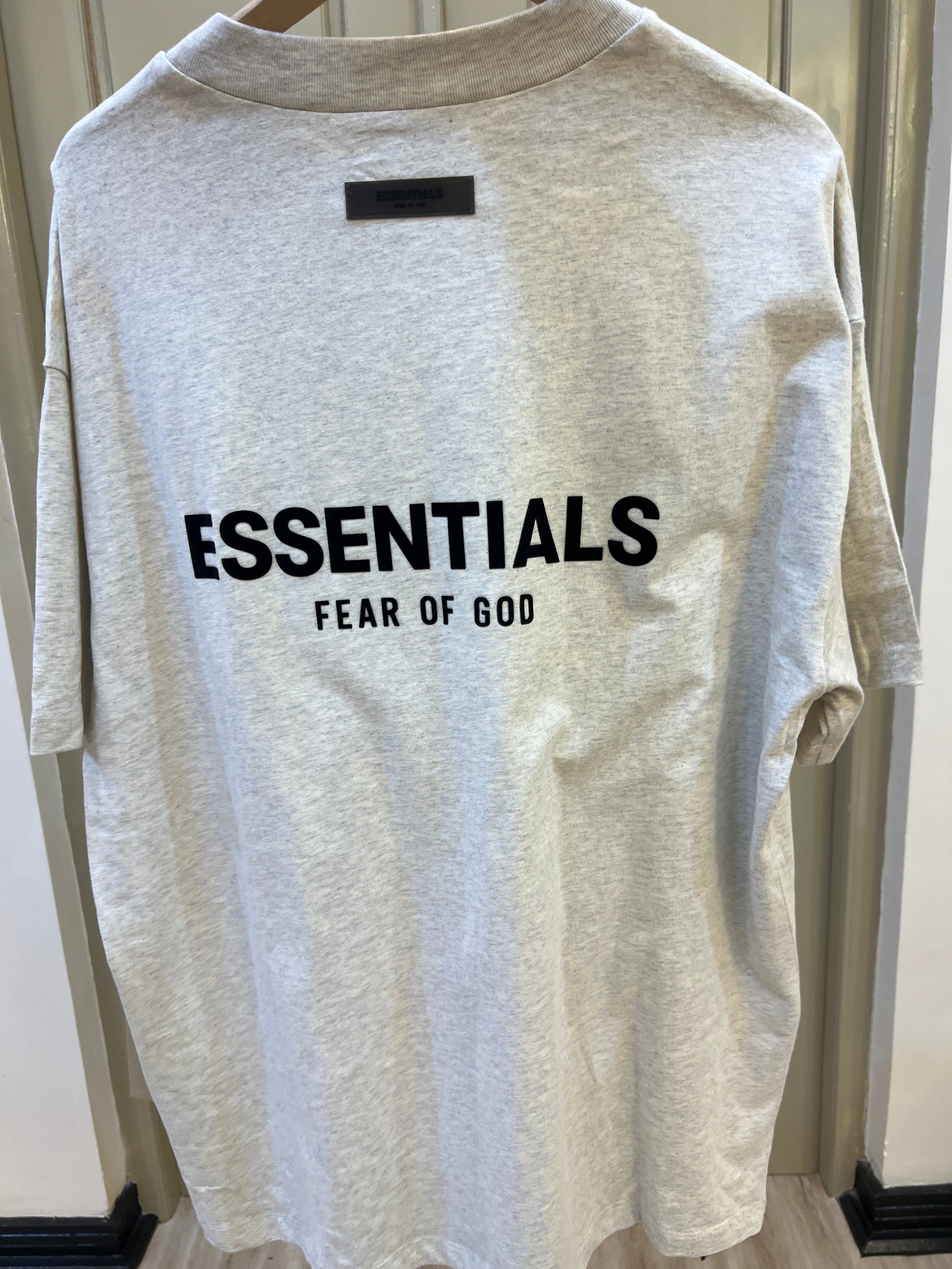 Fear of God Essentials t-shirt features a small black rubberized logo on the left chest