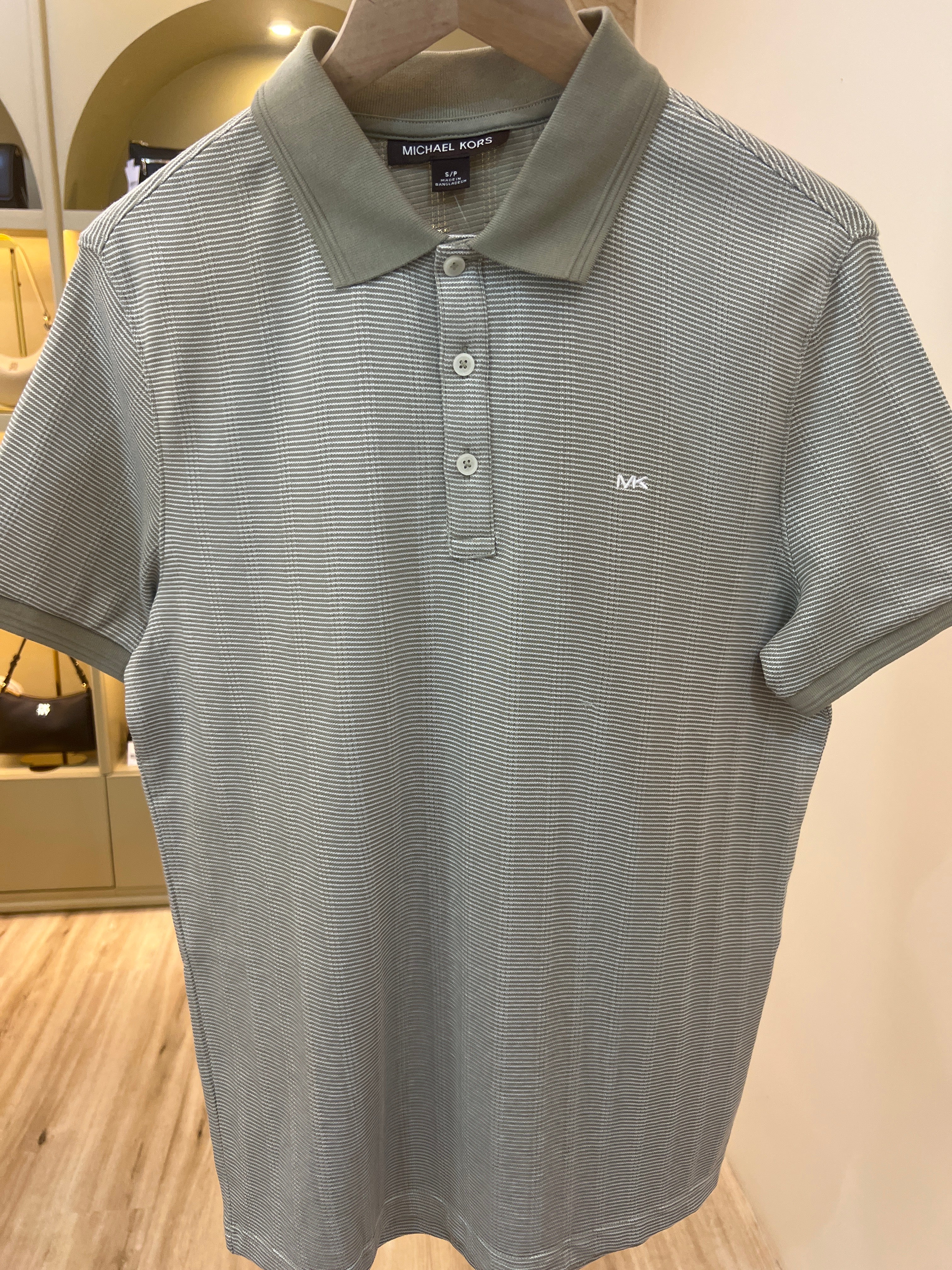 Michael Kors men's polo shirt featuring a striped design and the brand's logo on the chest