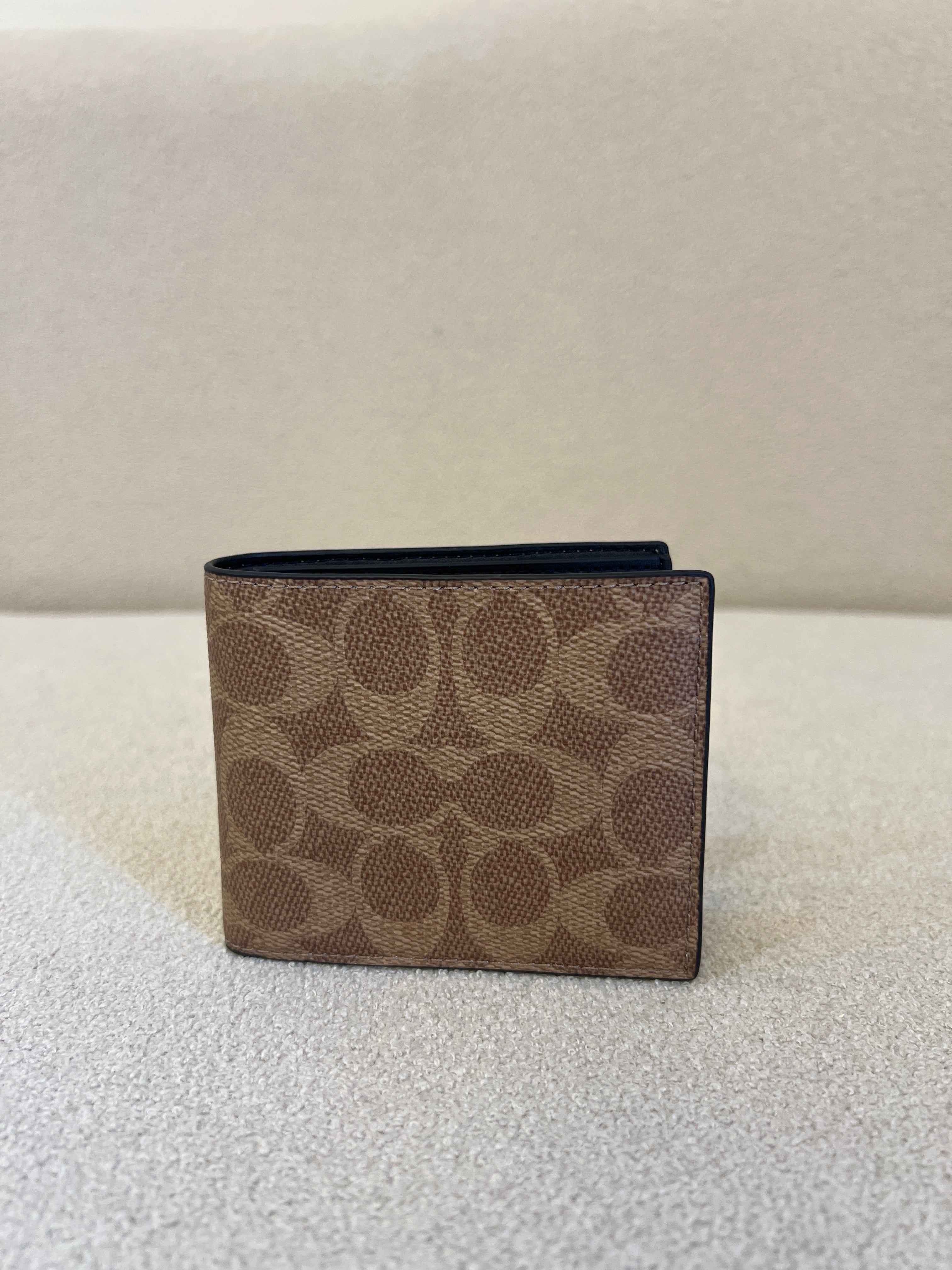 Coach ID Billfold Wallet in Signature Canvas, often found in Tan/Black or Mahogany