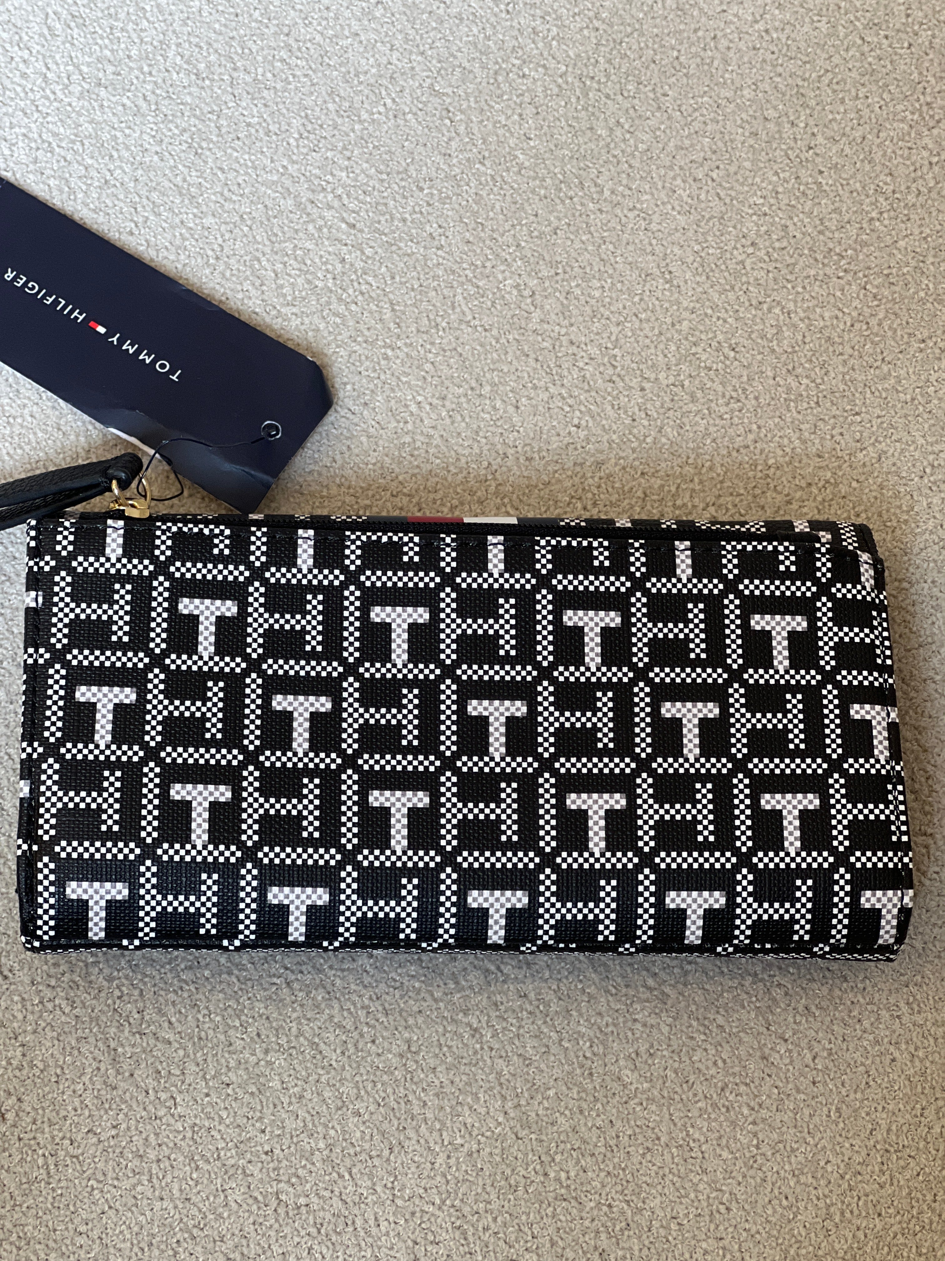 Tommy Hilfiger Waverly II-Flap Continental Wallet features a coated square monogram pattern and a varsity stripe