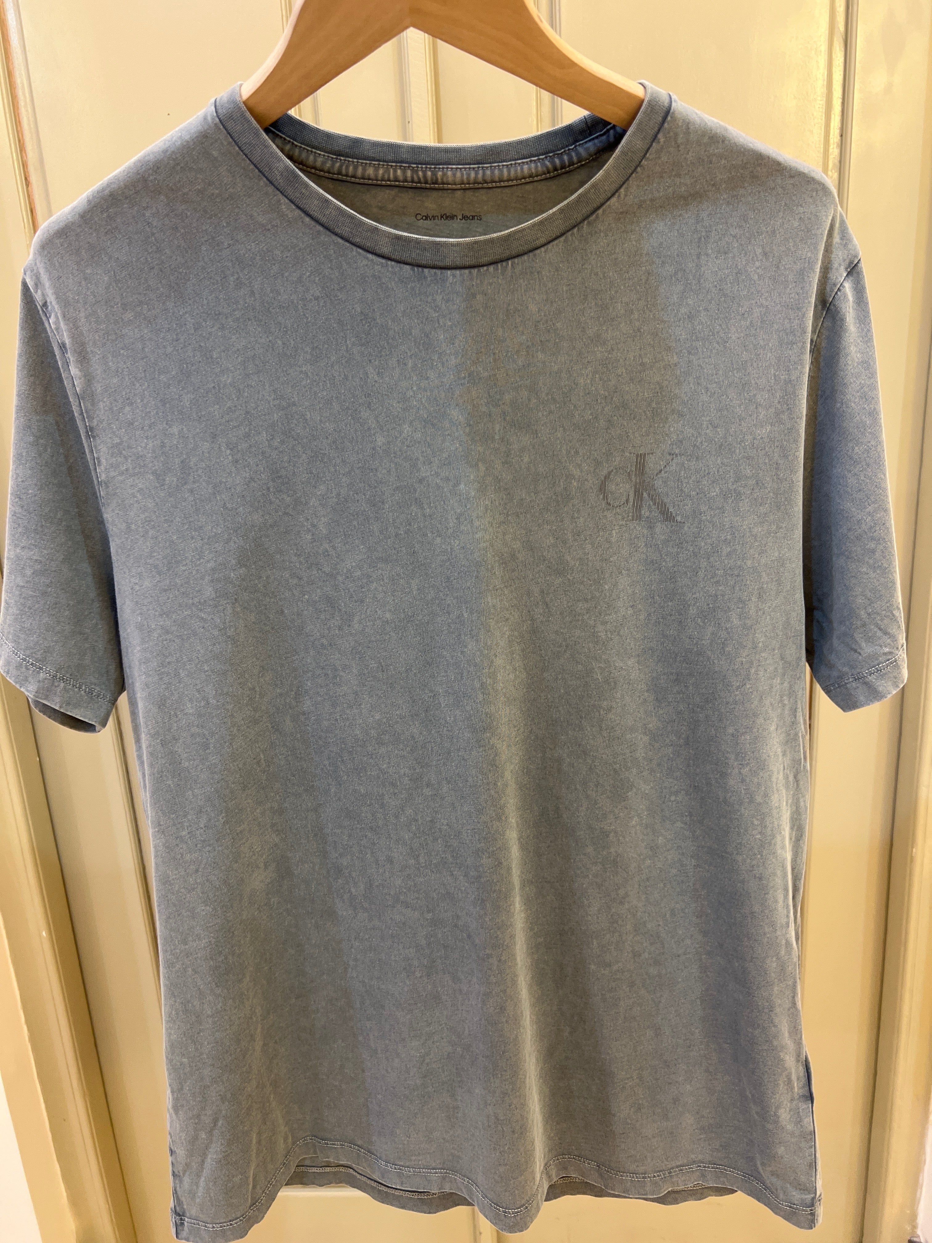 Calvin Klein Acid Wash Monogram Classic T-Shirt features a subtle monogram logo on the chest and a worn-in texture