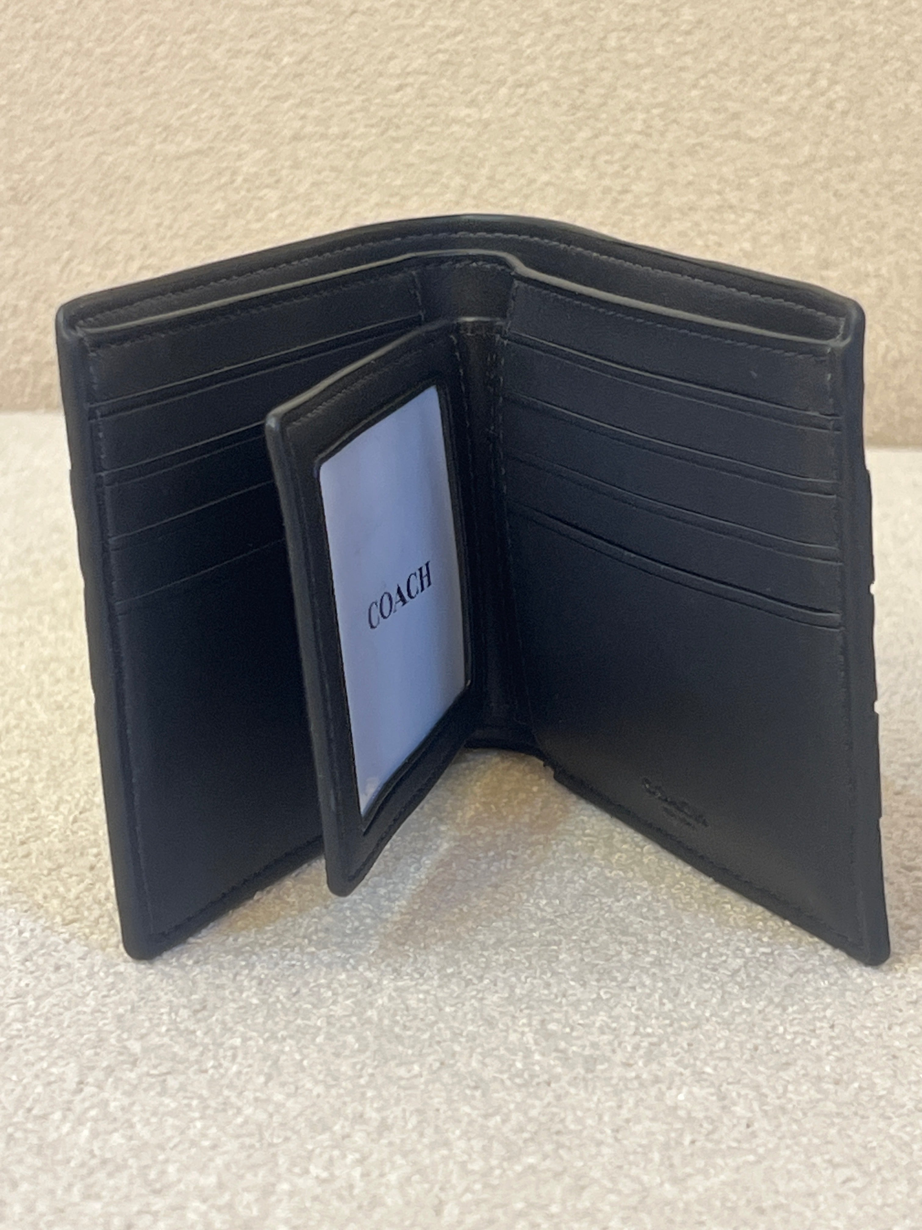 Coach 3-In-1 wallet featuring a black signature canvas design accented with blue and white varsity stripes