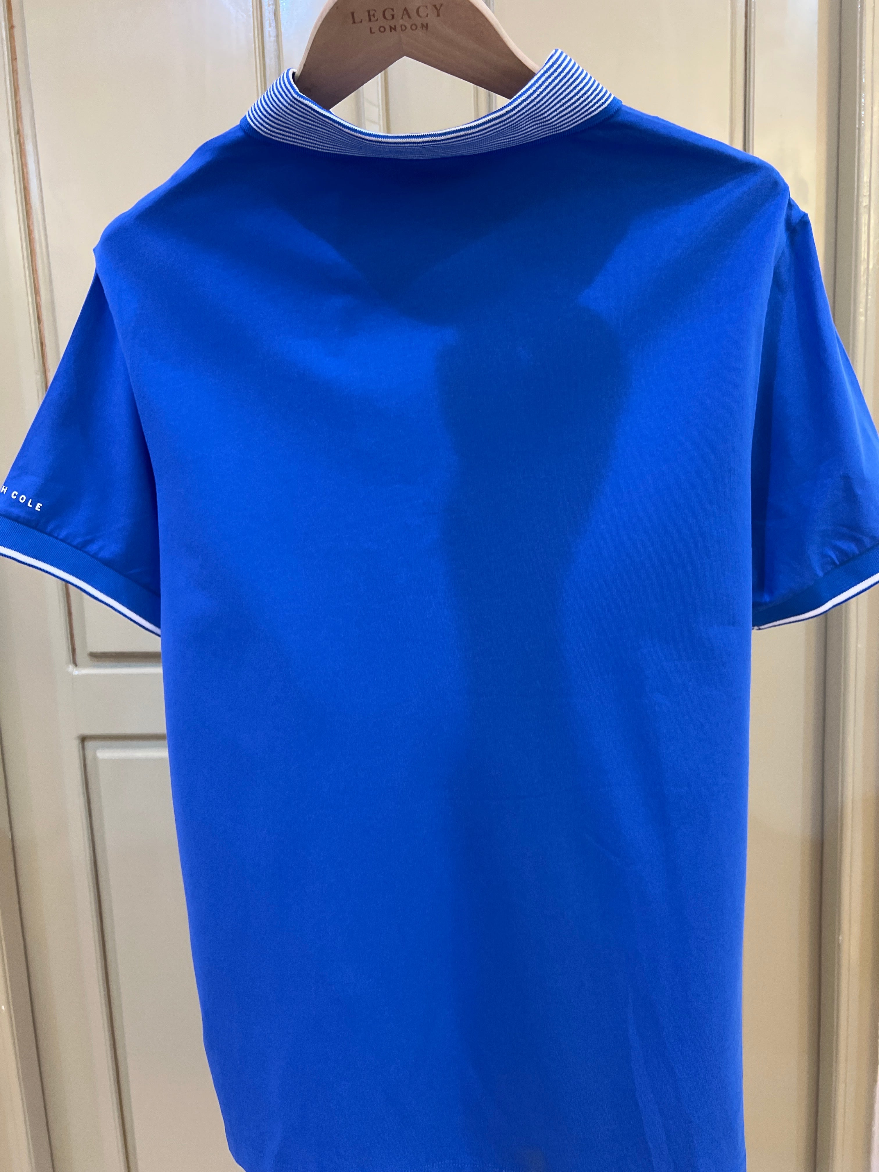 Kenneth Cole New York polo shirt features a distinctive striped ribbed collar and a two-button placket