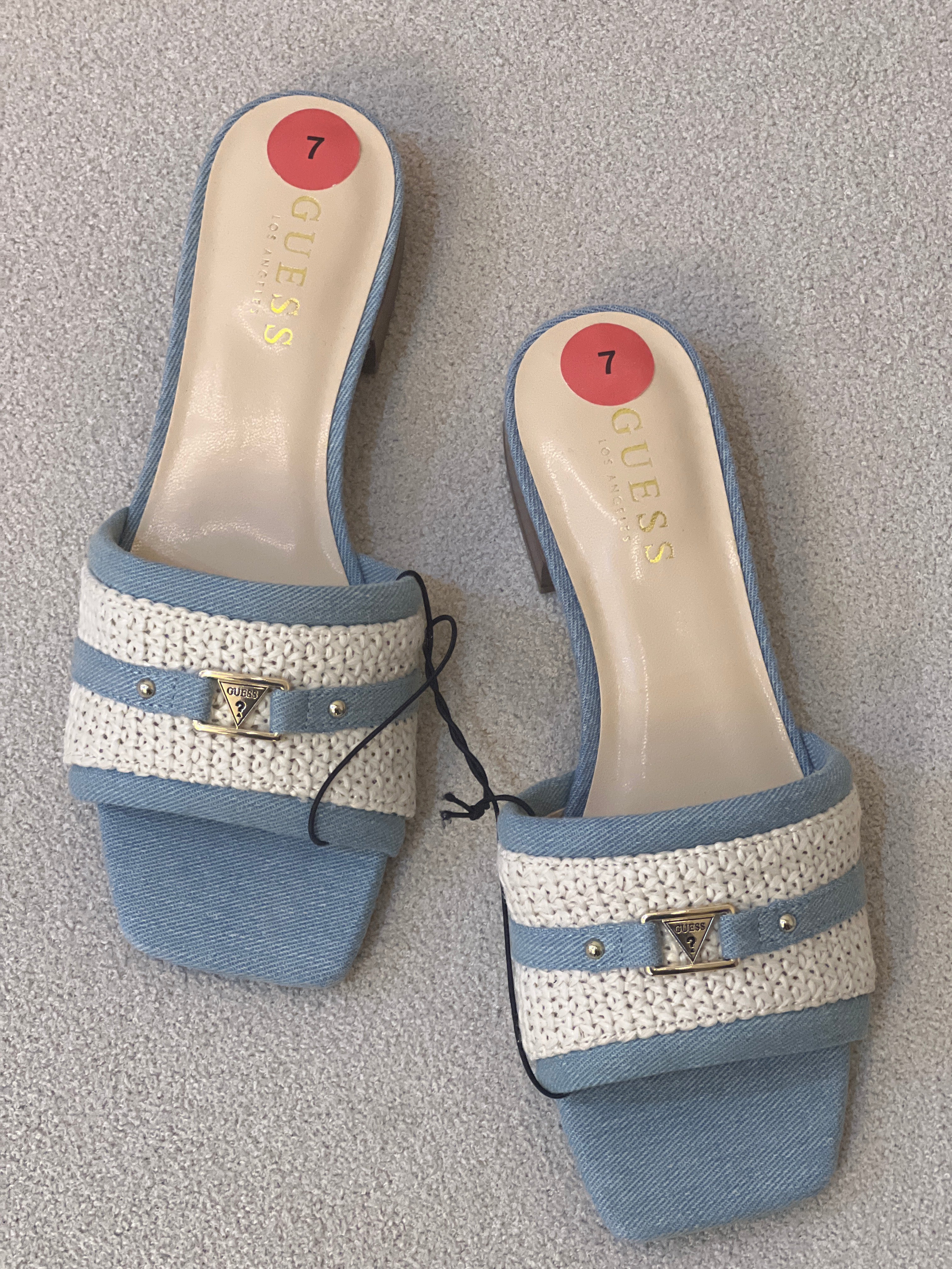 Guess textured denim slip-on sandals feature a woven straw band, a small block heel, and a gold-tone logo buckle detail