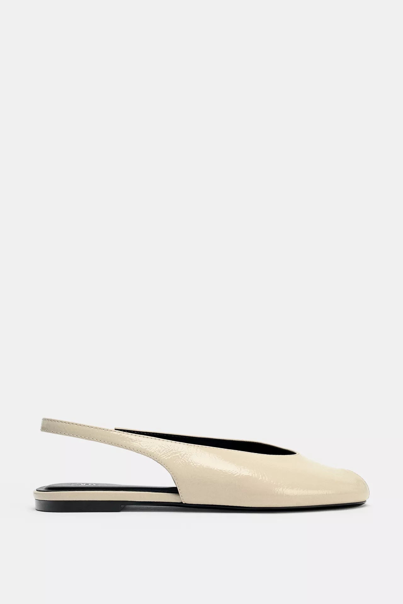 cream-colored Zara pointed-toe slingback flats feature a patent leather finish and an elasticated heel strap