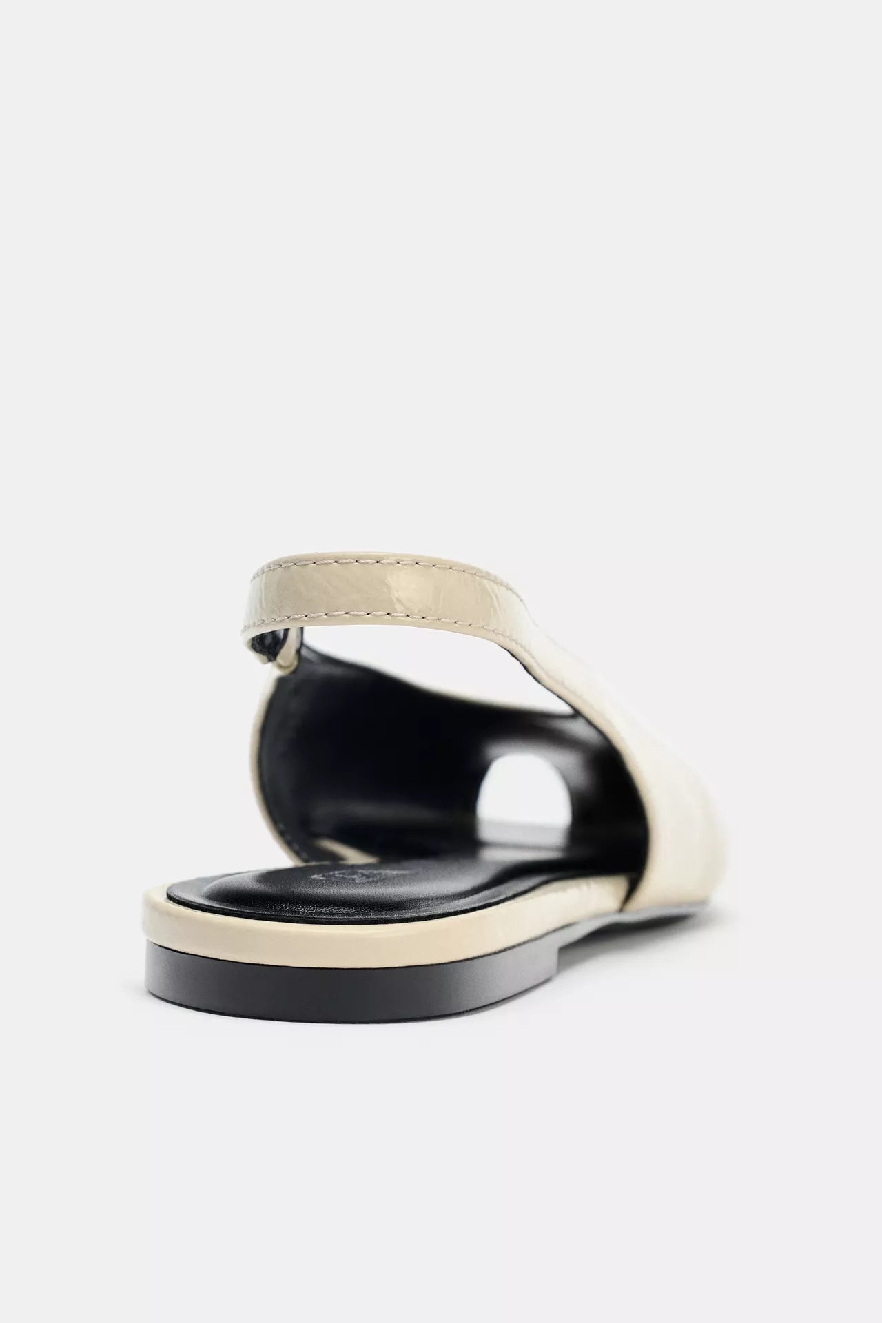 cream-colored Zara pointed-toe slingback flats feature a patent leather finish and an elasticated heel strap