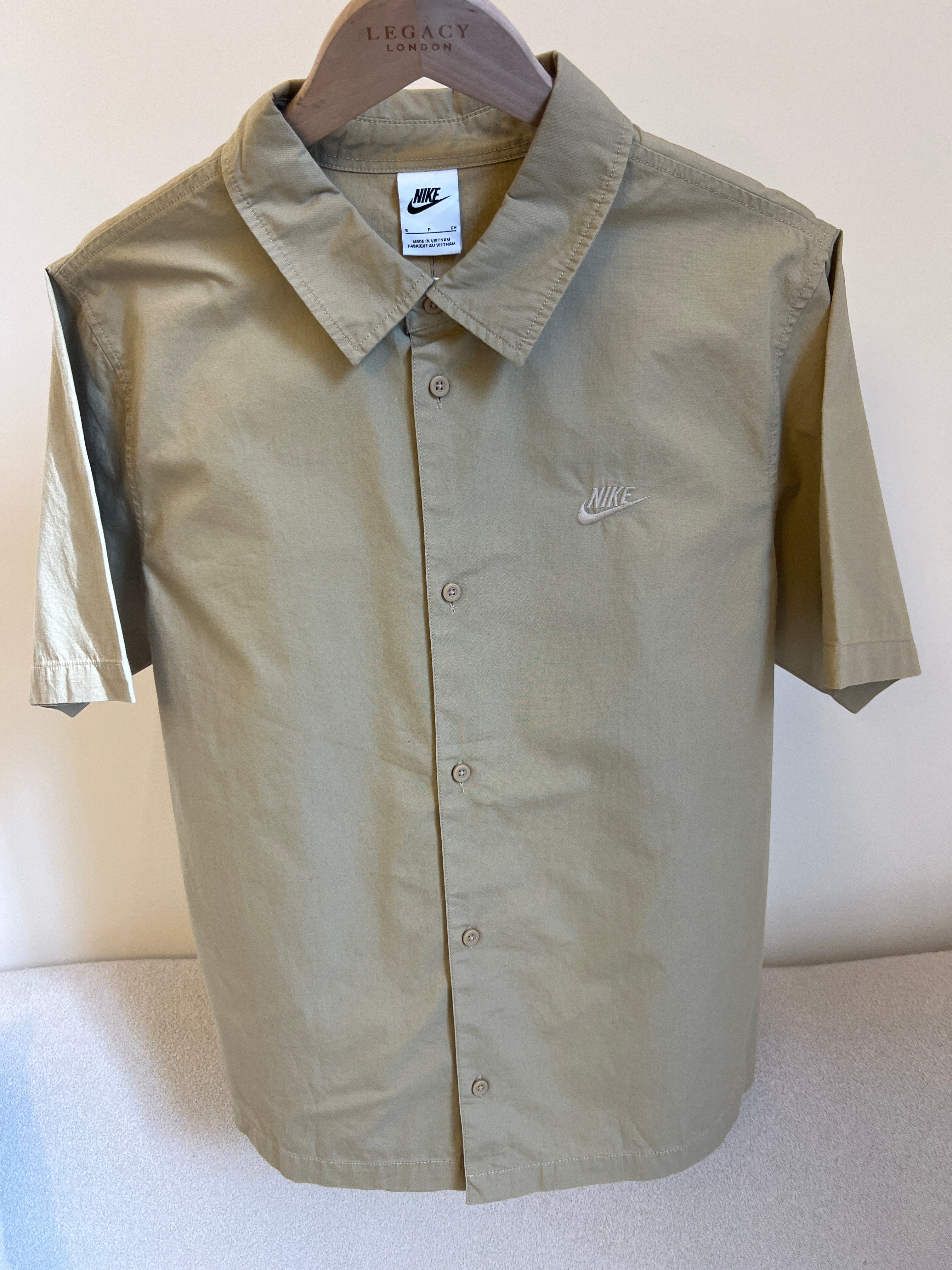 Nike Club short sleeve woven shirt features an embroidered Futura logo on the chest