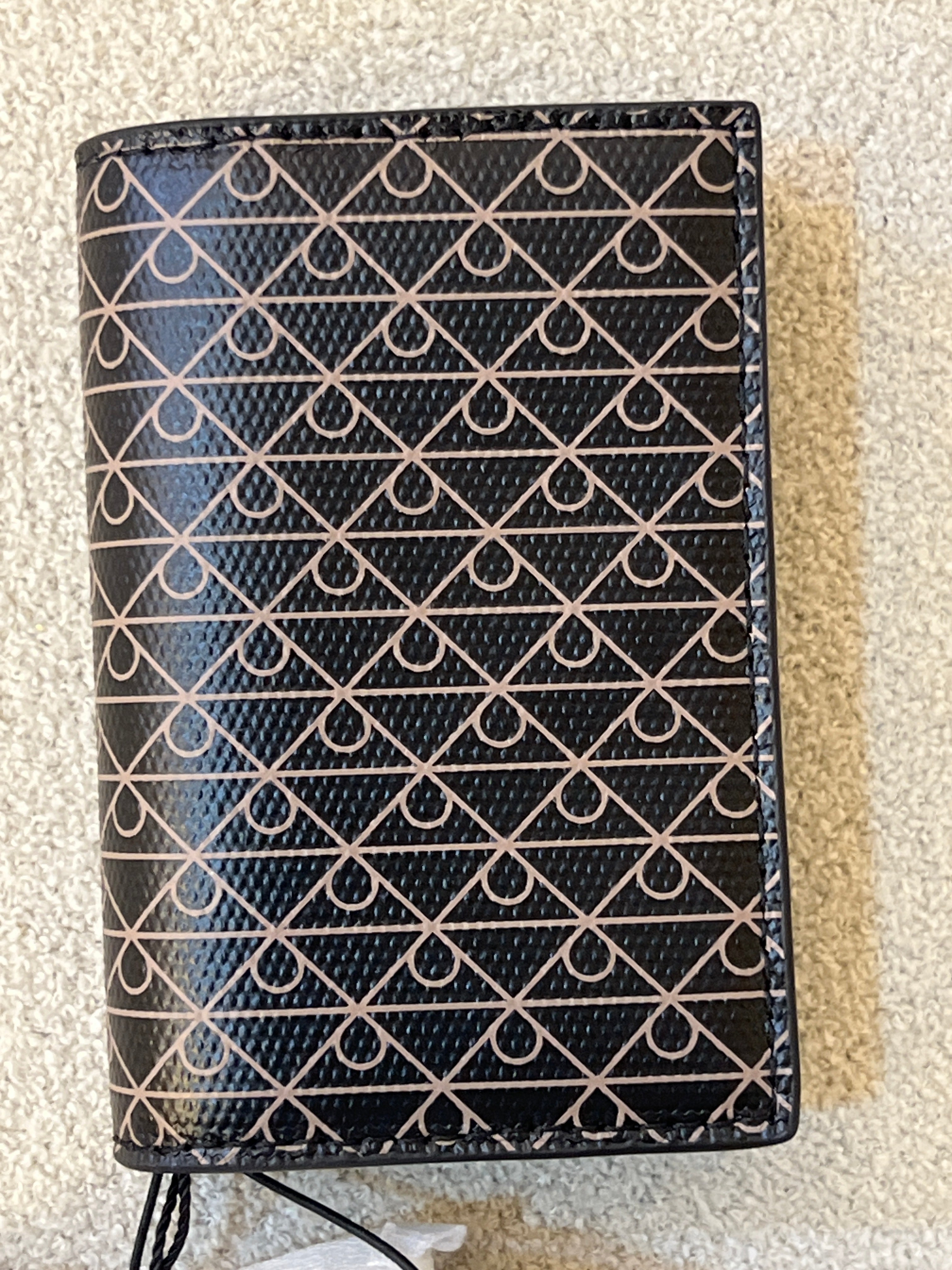 Calvin Klein wallet features a signature monogram logo motif pattern