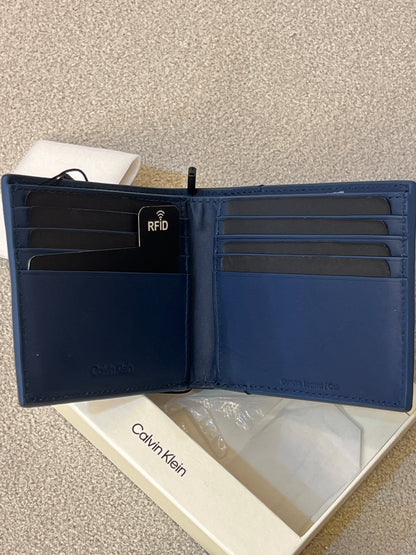 Calvin Klein wallet features a minimalist design with a small silver logo stud on the corner