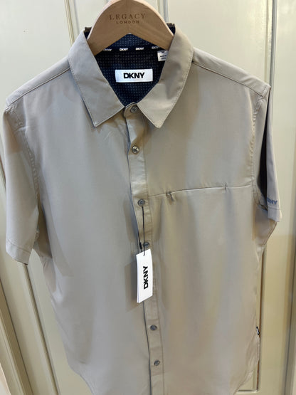 DKNY short-sleeve button-up shirt features a dark inner collar lining and a chest pocket
