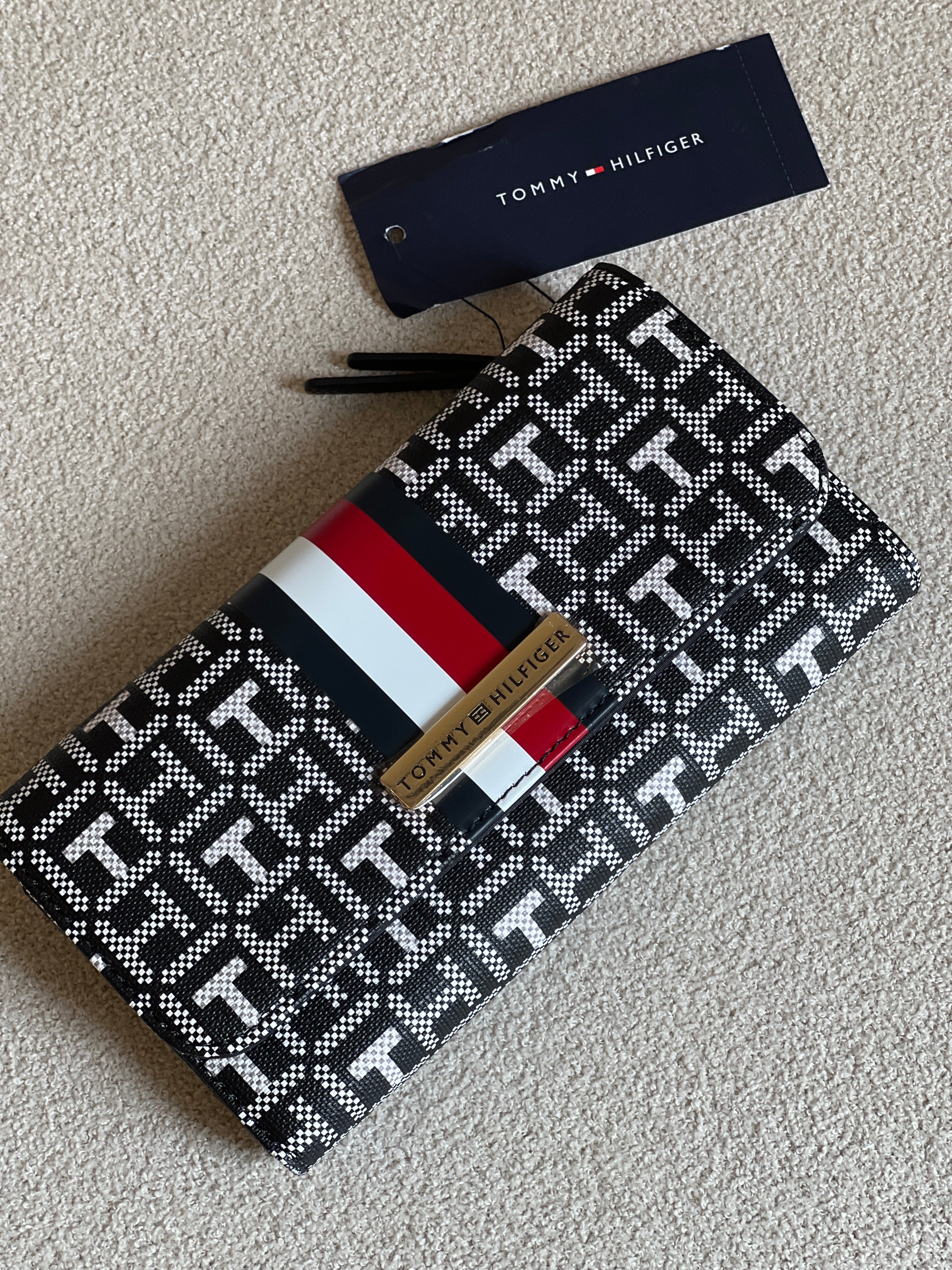 Tommy Hilfiger Waverly II-Flap Continental Wallet features a coated square monogram pattern and a varsity stripe