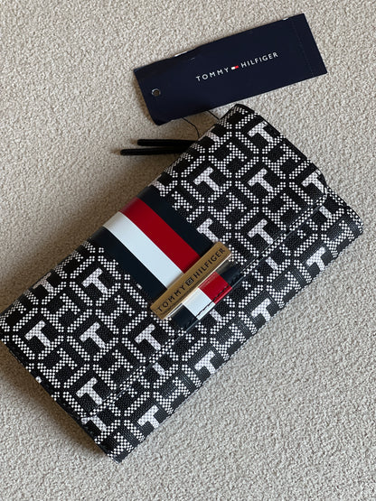 Tommy Hilfiger Waverly II-Flap Continental Wallet features a coated square monogram pattern and a varsity stripe
