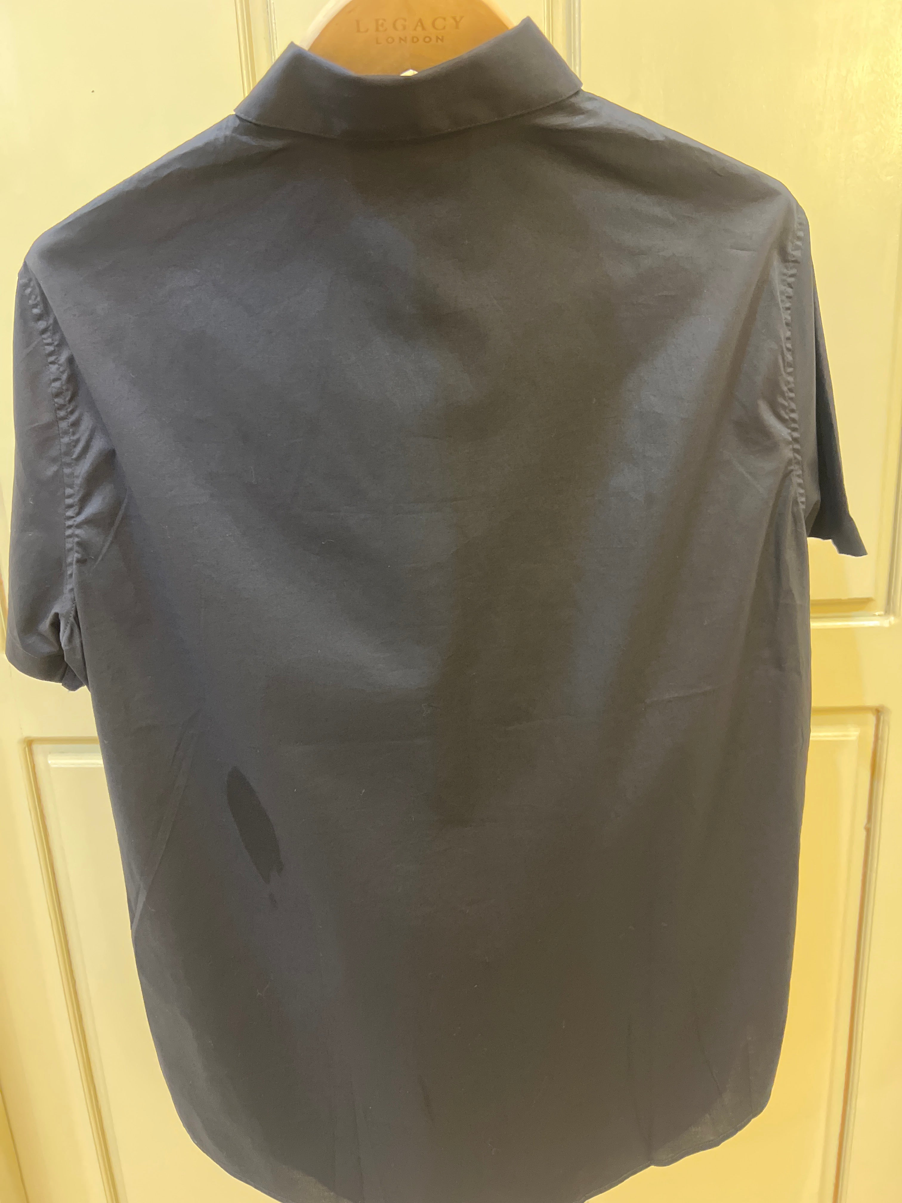 Armani Exchange short sleeve shirt features a sleek black design with metallic button detailing