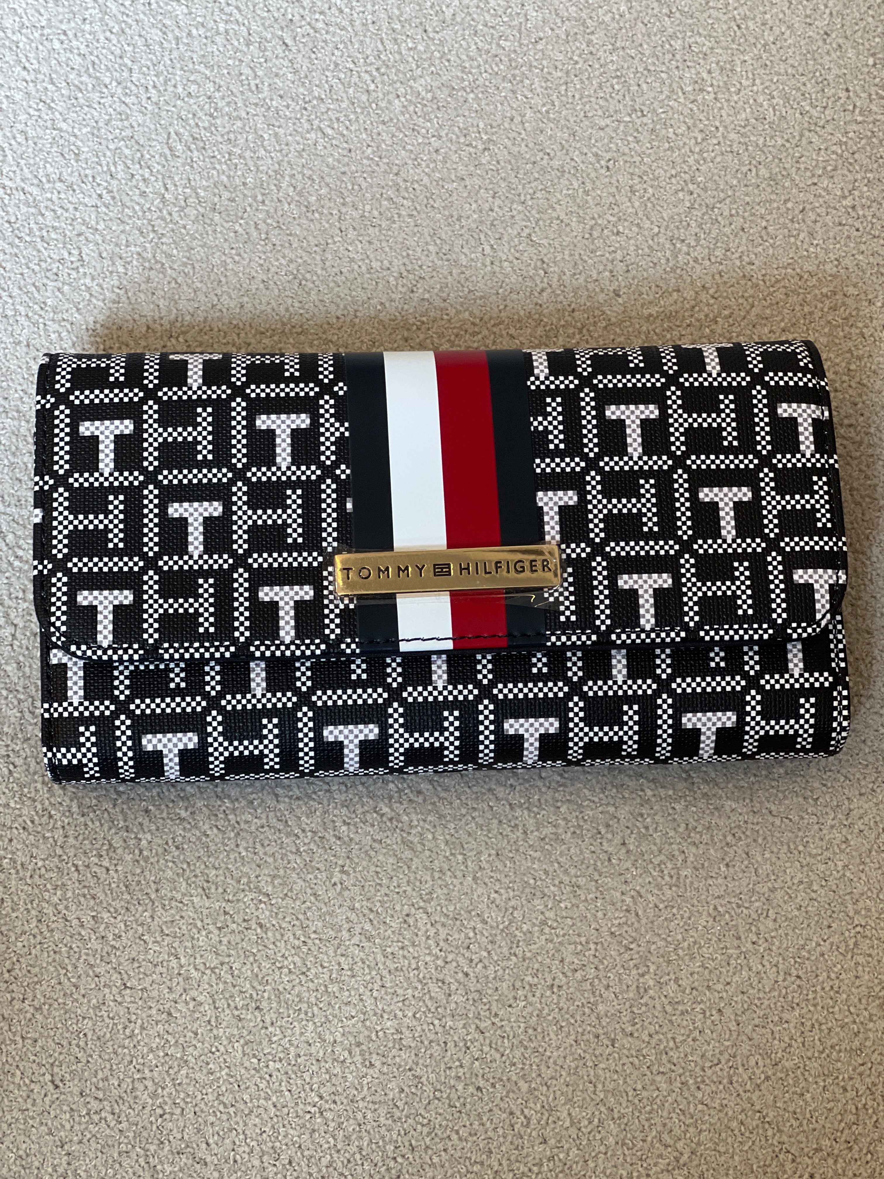 Tommy Hilfiger Waverly II-Flap Continental Wallet features a coated square monogram pattern and a varsity stripe