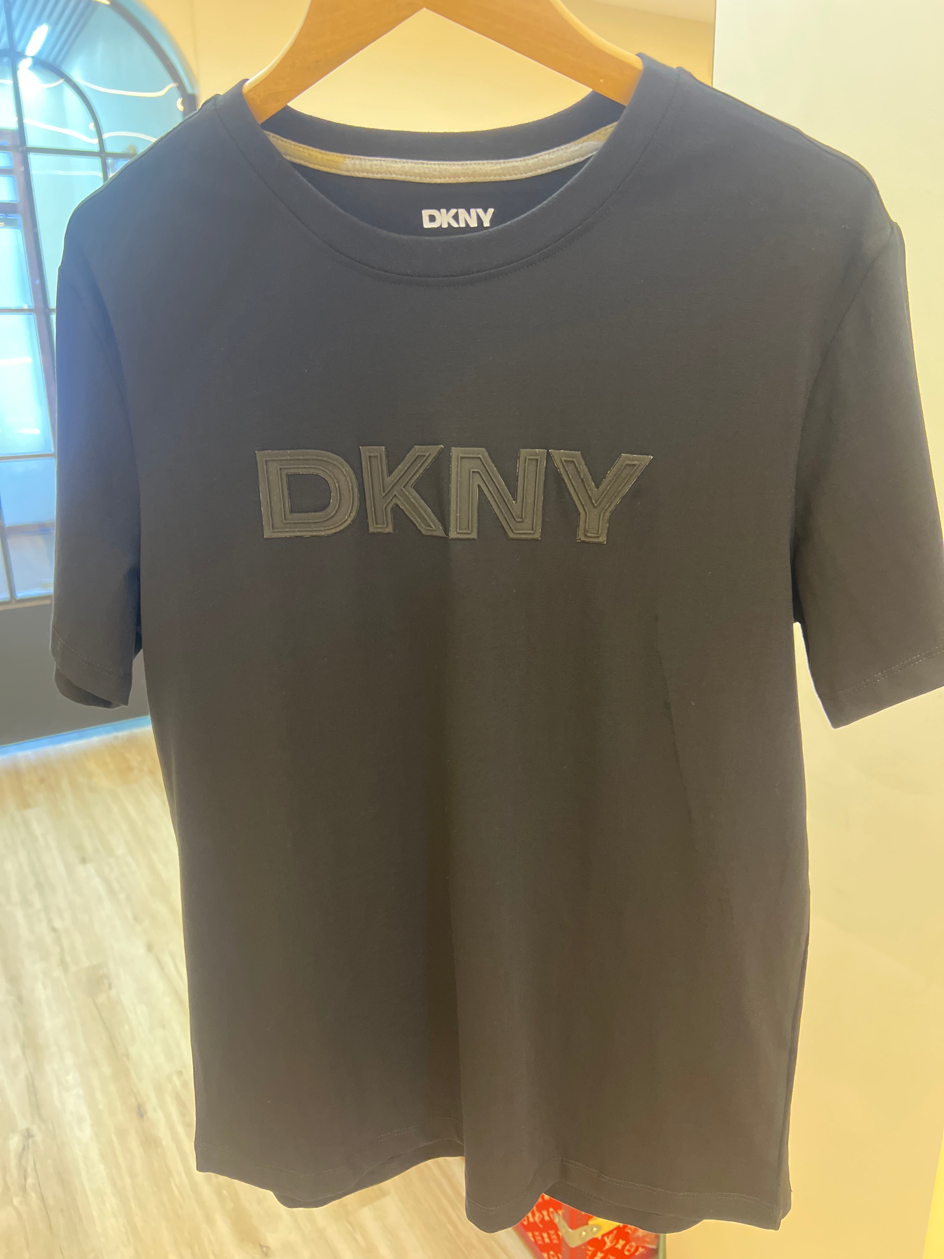 Black DKNY crewneck T-shirt featuring a prominent tonal block logo on the chest