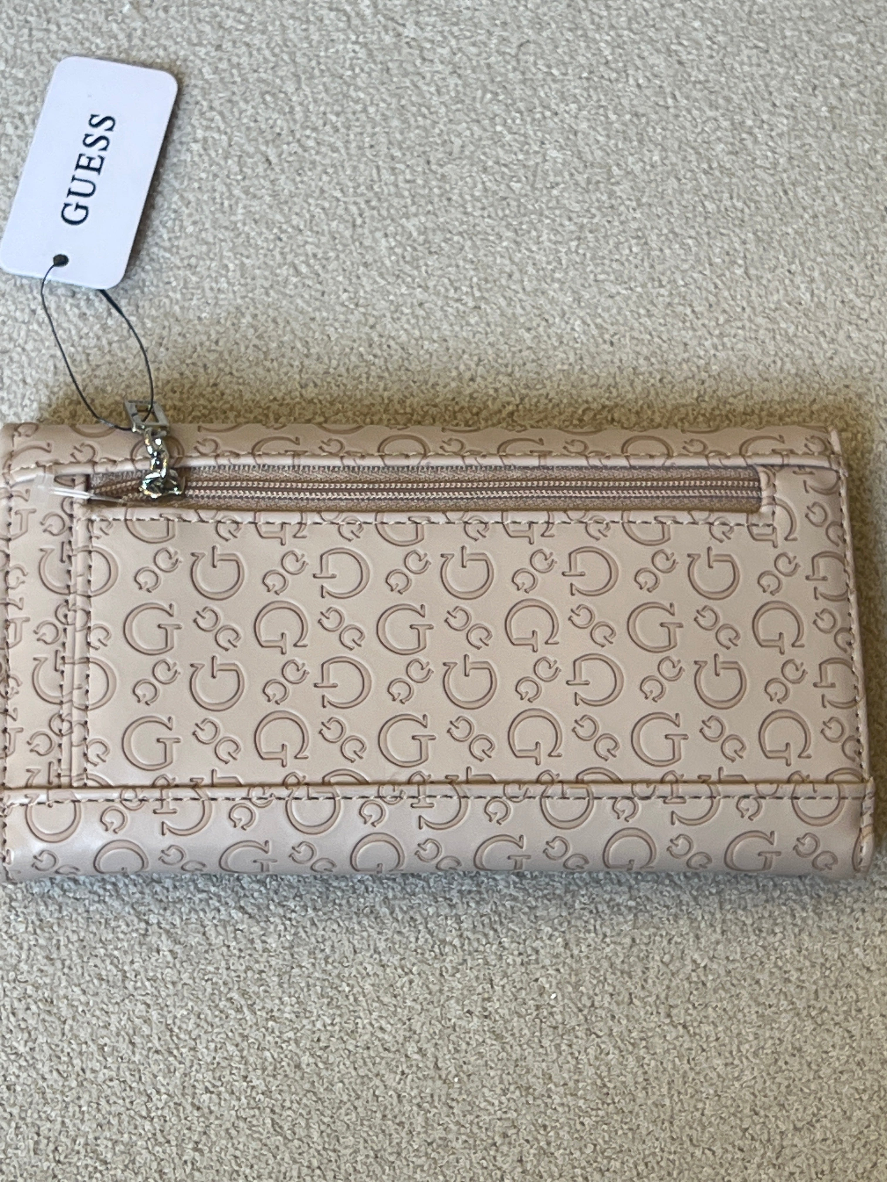 Guess "Viviette" SLG slim clutch wallet in a latte color with an all-over embossed logo pattern