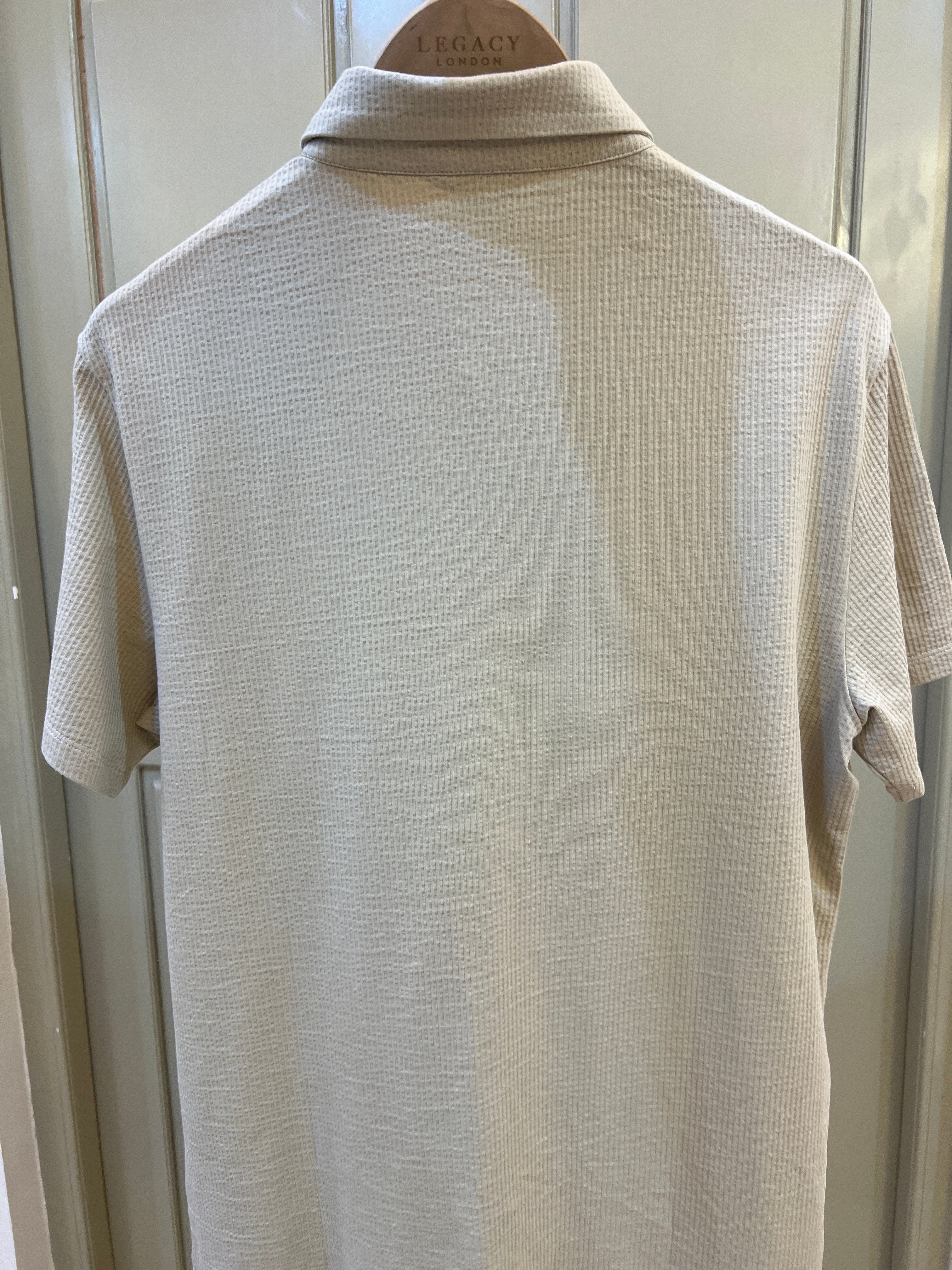 Calvin Klein short-sleeve button-down shirt features a textured fabric finish and subtle logo embroidery