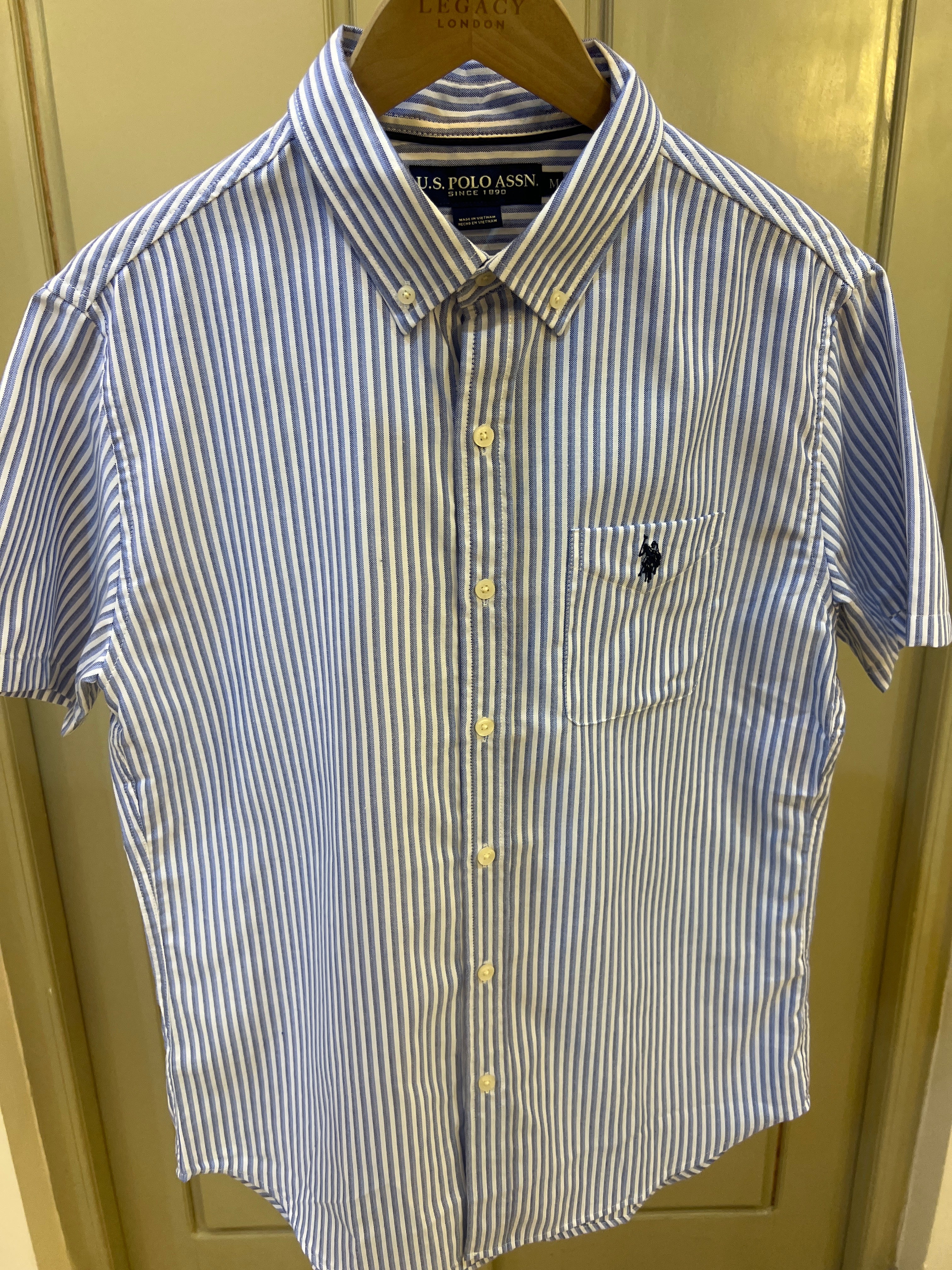 S. Polo Assn. striped shirt features a button-down collar and an embroidered logo on the chest pocket