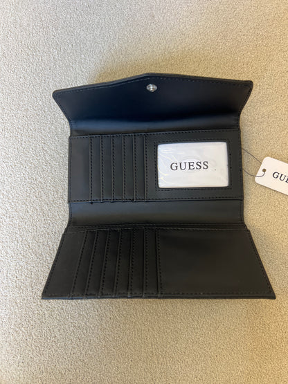 Guess clutch wallet featuring an all-over monogram logo print and a snap-flap closure