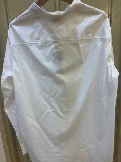 White long-sleeve Armani Exchange button-up shirt features a prominent cursive logo embroidered on the chest