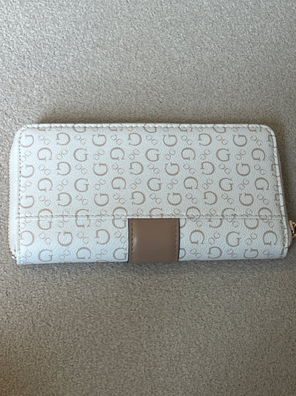 Guess Isabella zip-around wallet features a white printed design with a tan center strap and a prominent gold logo plaque