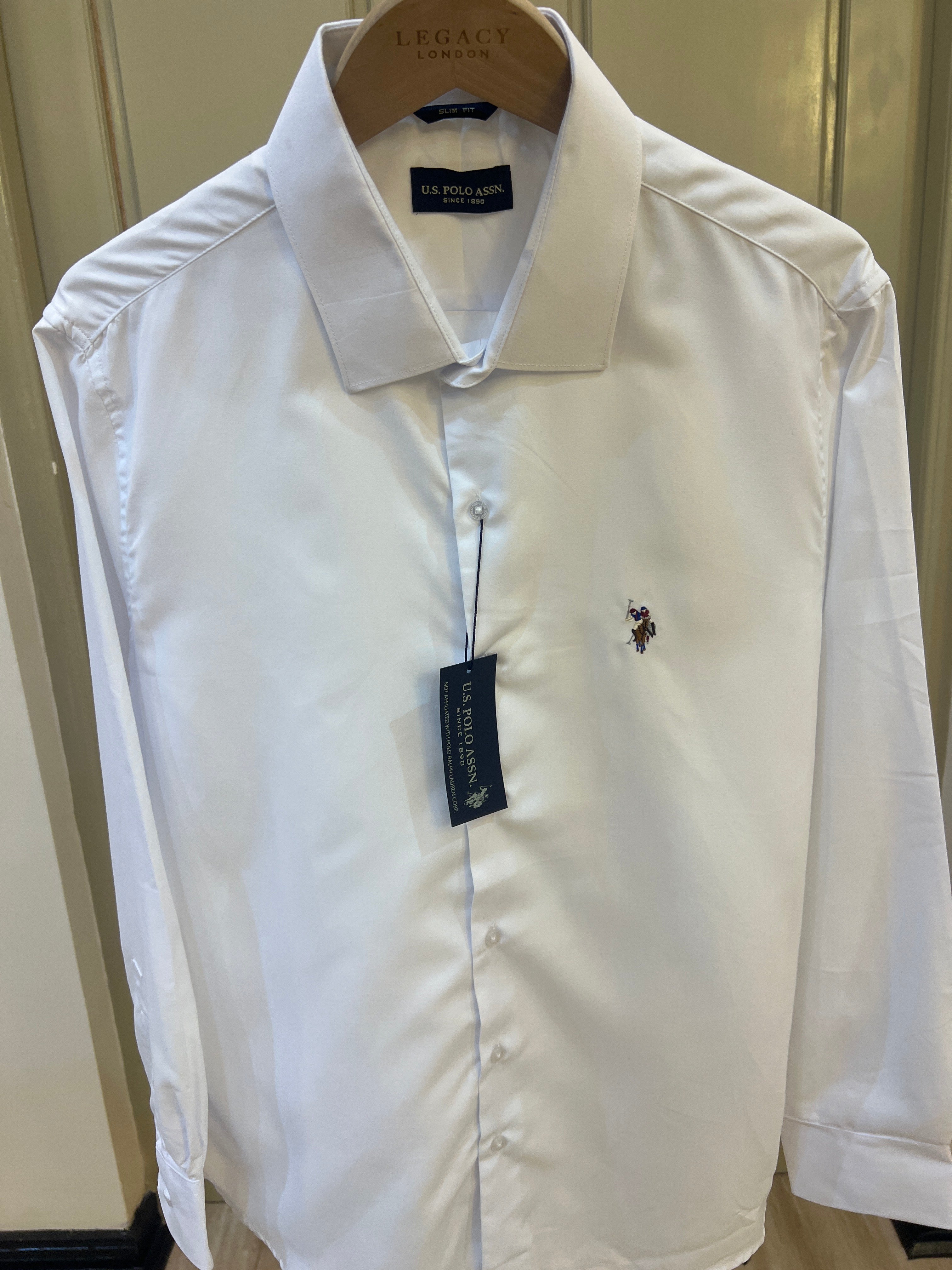 U.S. Polo Assn. long-sleeve button-up shirt features a classic embroidered polo player logo on the chest