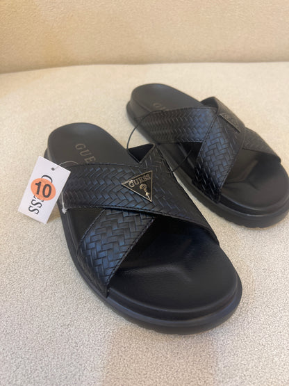 GUESS black Banlin slide sandals featuring a woven design and a silver triangular logo