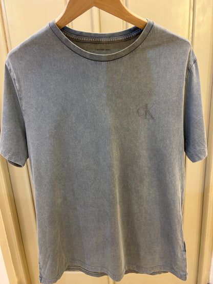 Calvin Klein Acid Wash Monogram Classic T-Shirt features a subtle monogram logo on the chest and a worn-in texture
