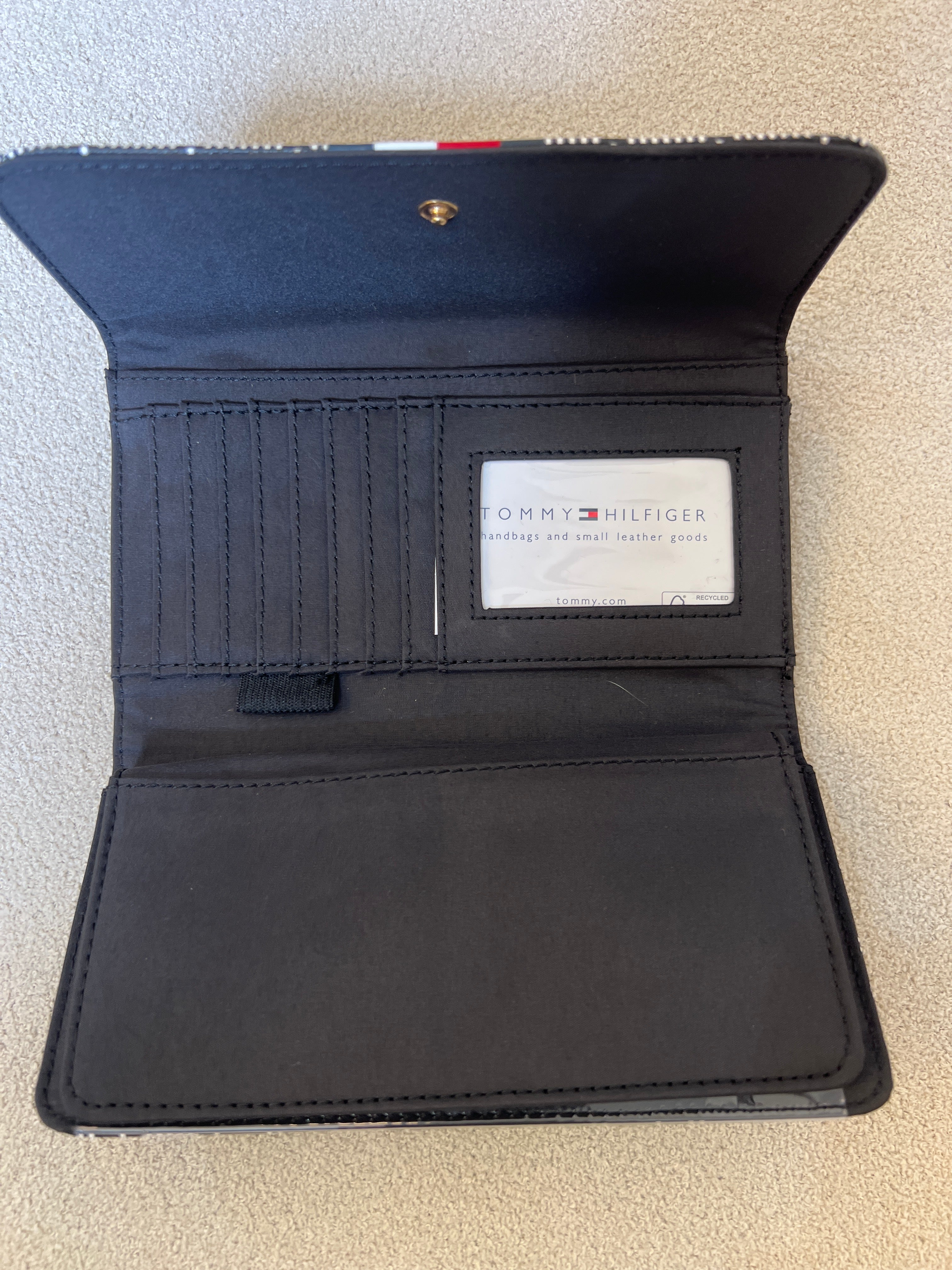 Tommy Hilfiger Waverly II-Flap Continental Wallet features a coated square monogram pattern and a varsity stripe