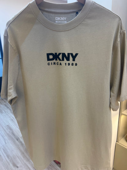 DKNY t-shirt, likely featuring a crew neck and short sleeves, is branded with a prominent "DKNY CIRCA 1989" logo on the chest and back print