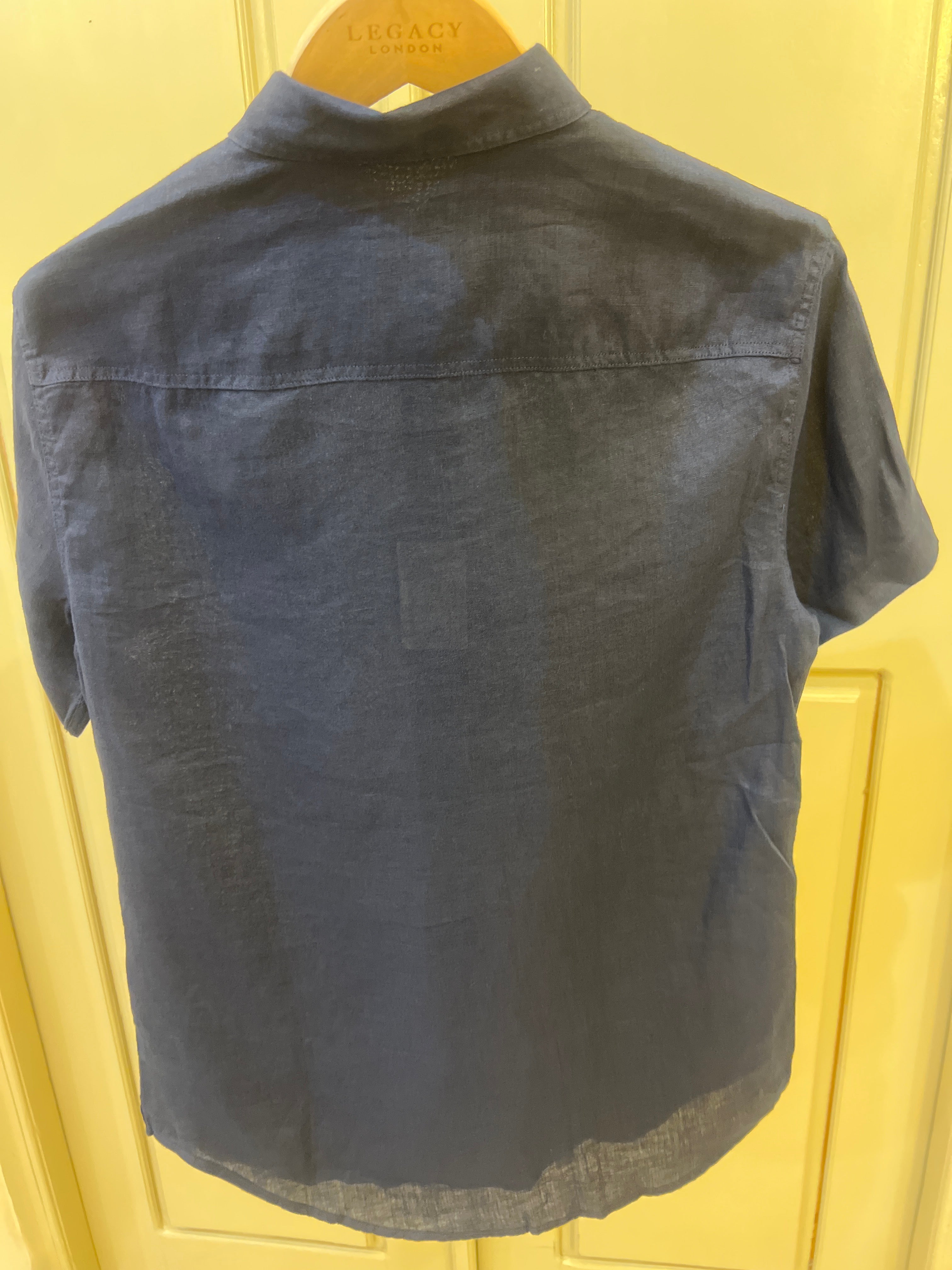 Armani Exchange shirt features a dark navy blue color and is made from a lightweight material