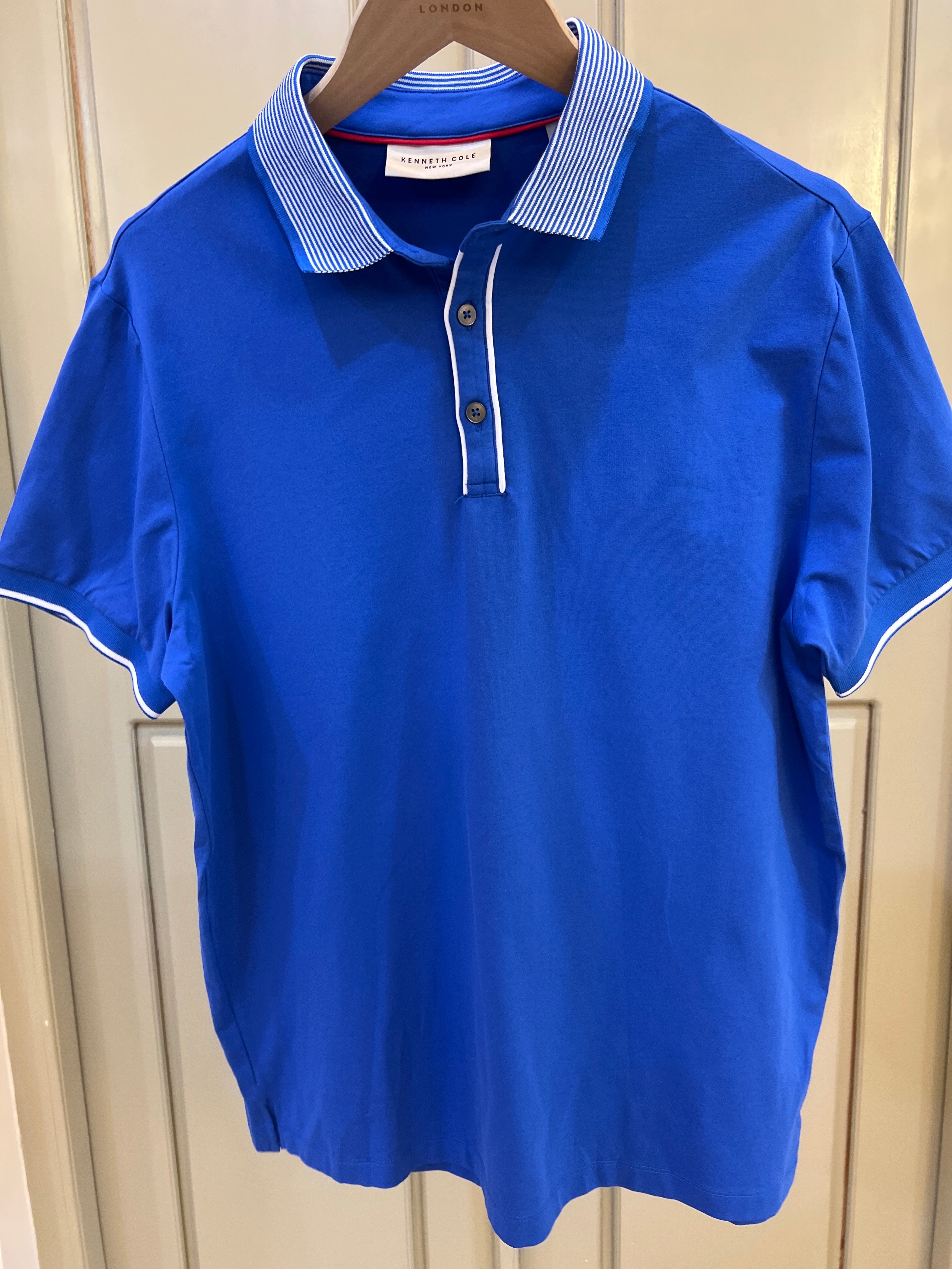 Kenneth Cole New York polo shirt features a distinctive striped ribbed collar and a two-button placket