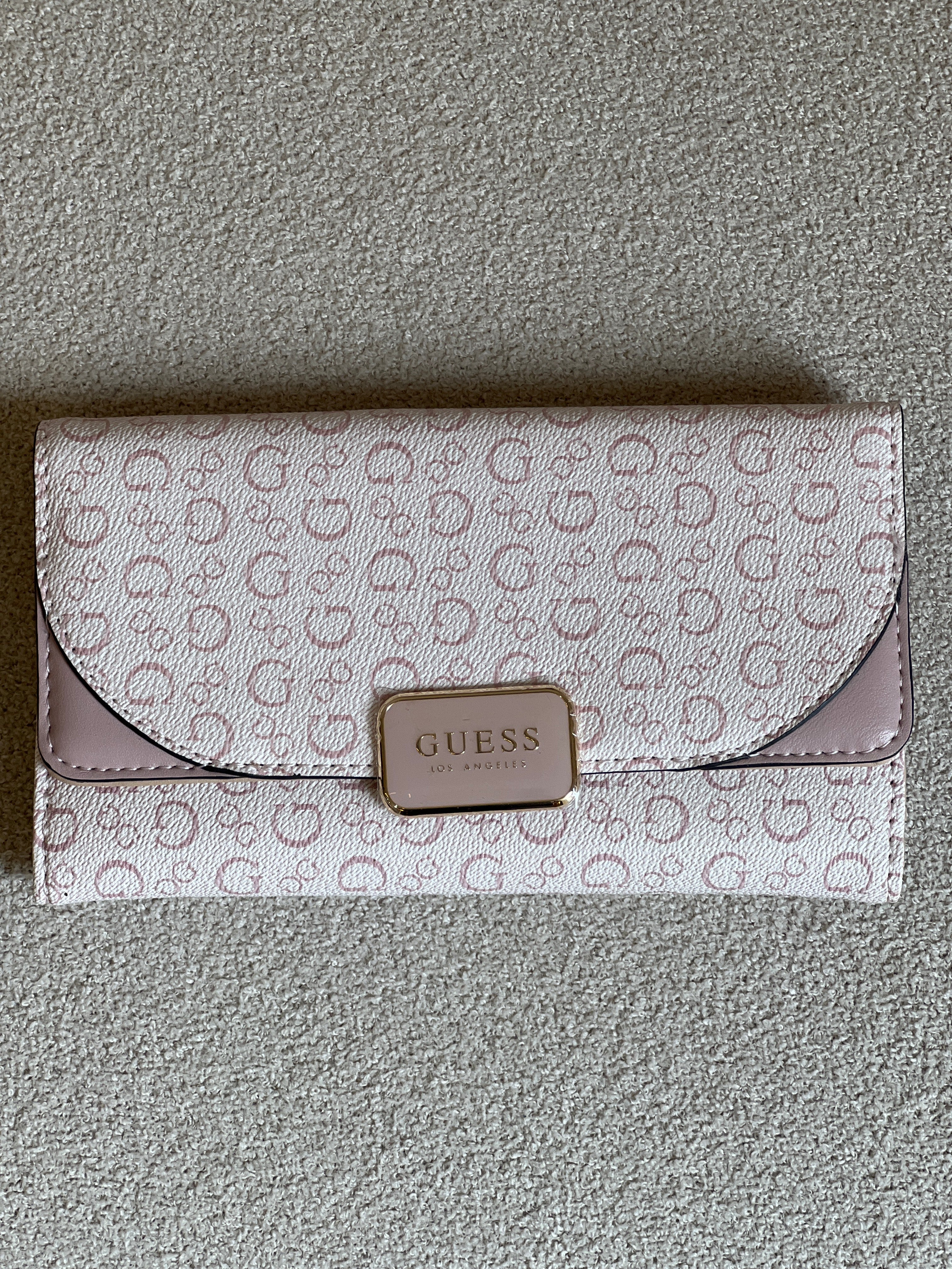 Guess wallet featuring a monogram logo pattern and a structured metallic logo plate
