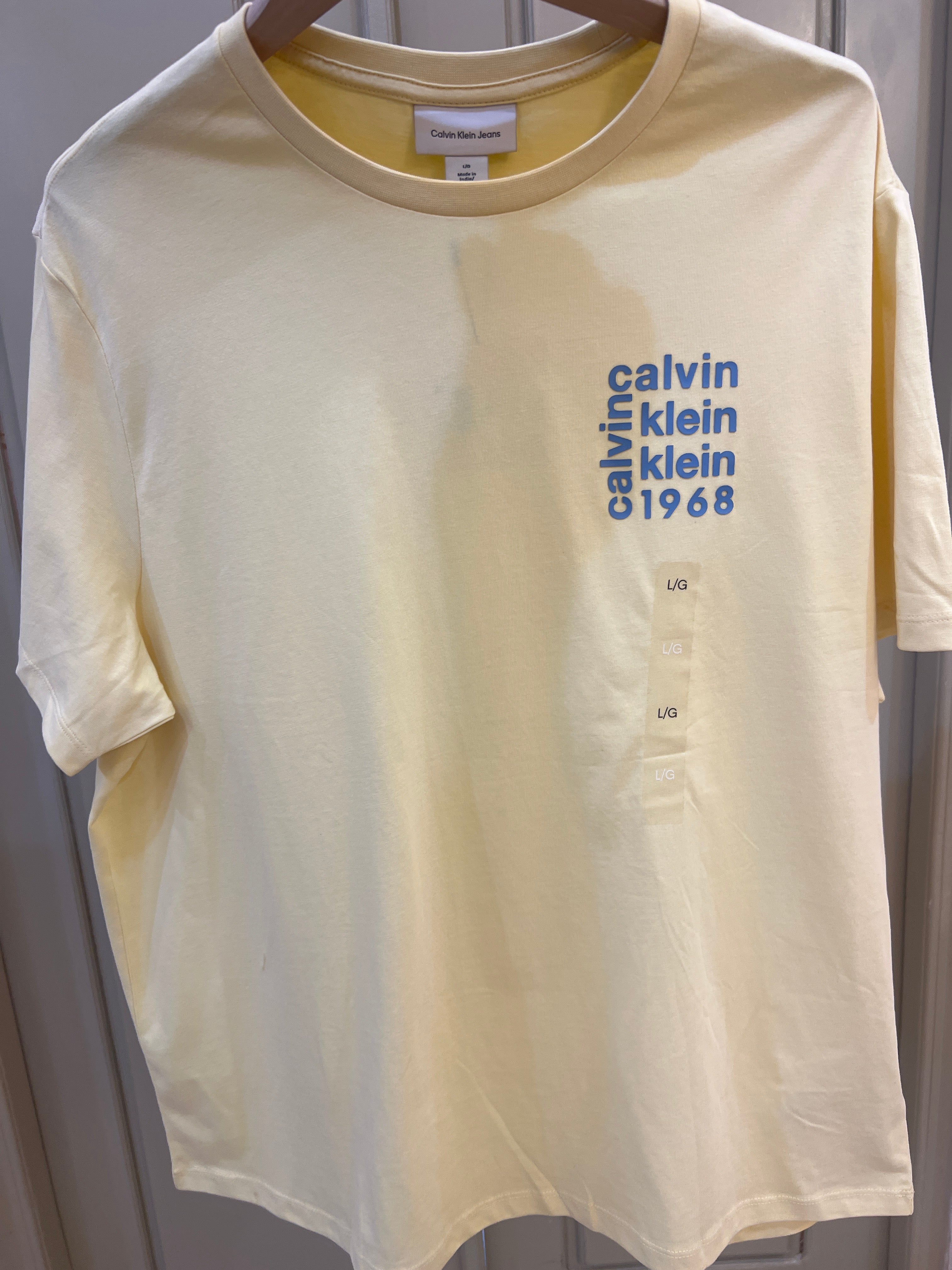 Calvin Klein Logo Square Graphic Relaxed T-Shirt features a blue stacked text logo on the chest