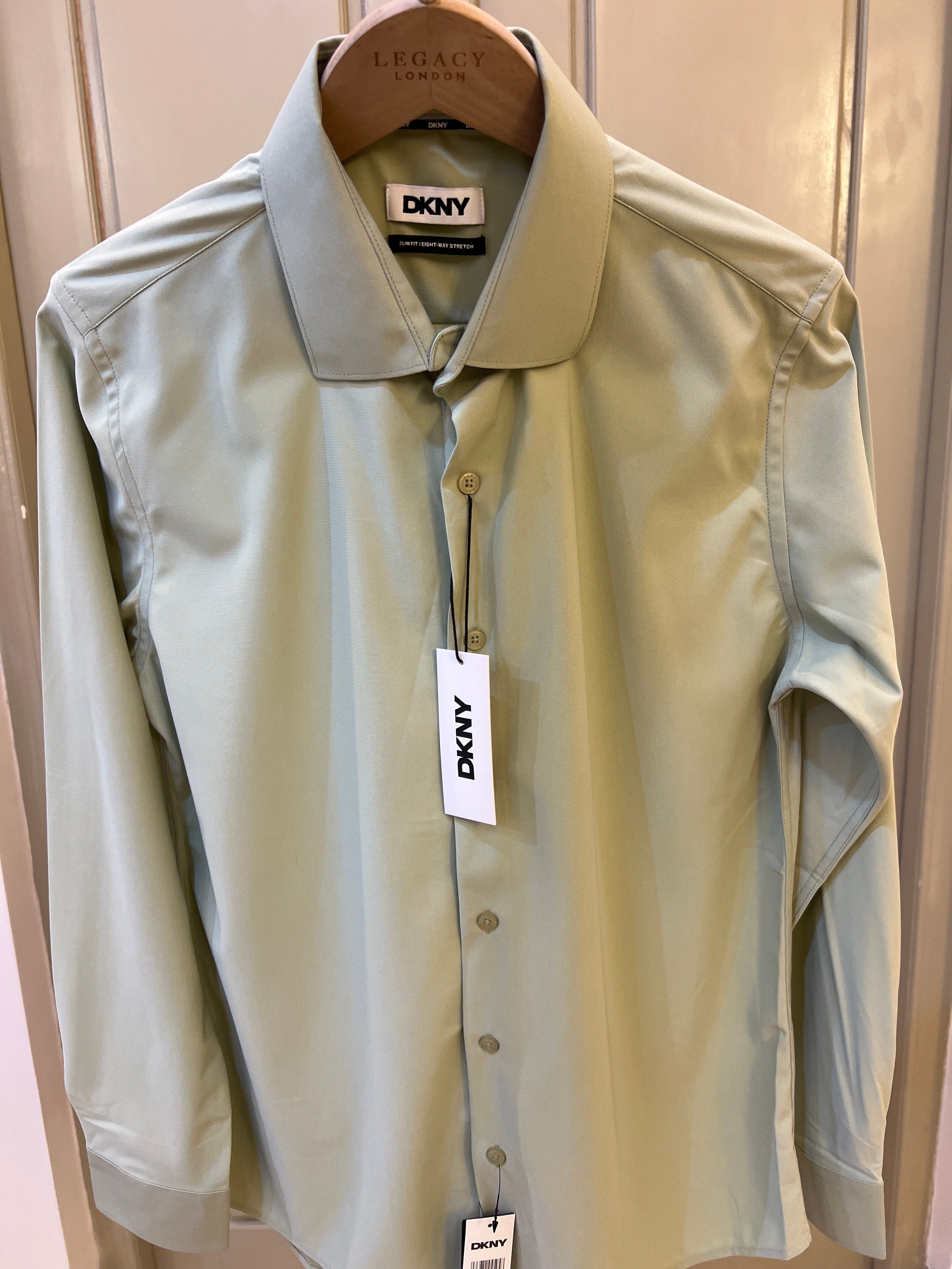 DKNY long-sleeve dress shirt features a classic button-down front and a structured collar