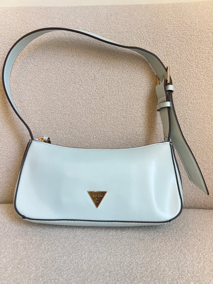 GUESS Tasha Mini Shoulder bag features a light blue synthetic exterior and a polished gold-tone triangular logo plaque