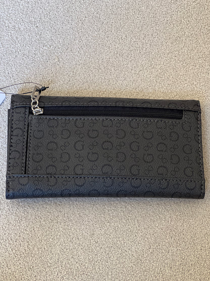 Guess clutch wallet featuring an all-over monogram logo print and a snap-flap closure