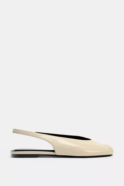 cream-colored Zara pointed-toe slingback flats feature a patent leather finish and an elasticated heel strap