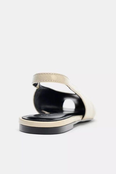 cream-colored Zara pointed-toe slingback flats feature a patent leather finish and an elasticated heel strap
